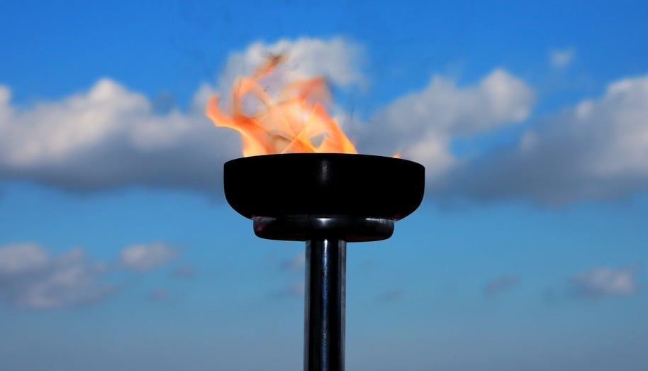 a torch on a cloudy blue sky